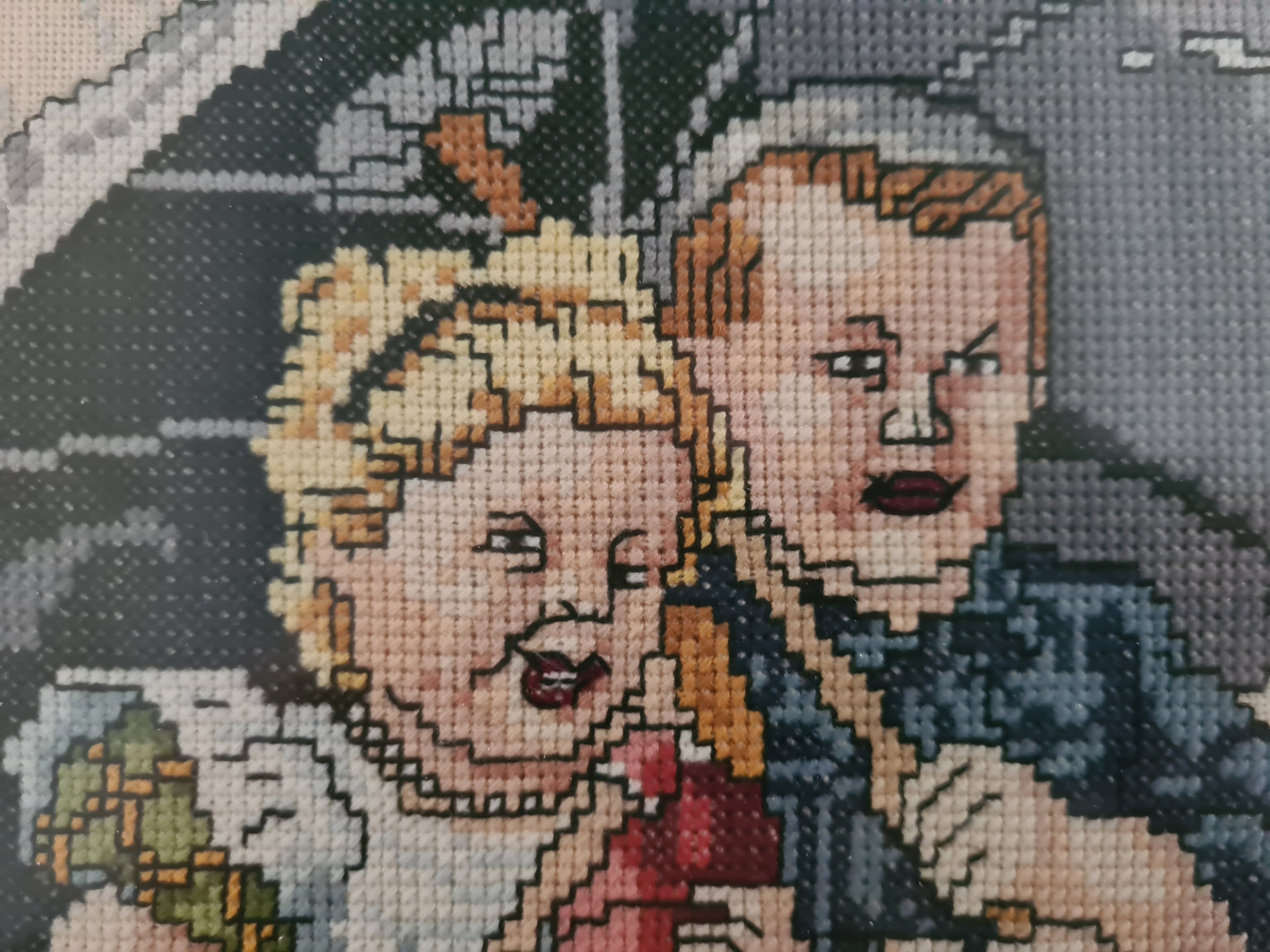 Ingelijst borduurwerk Ot & Sien onder moeders paraplu