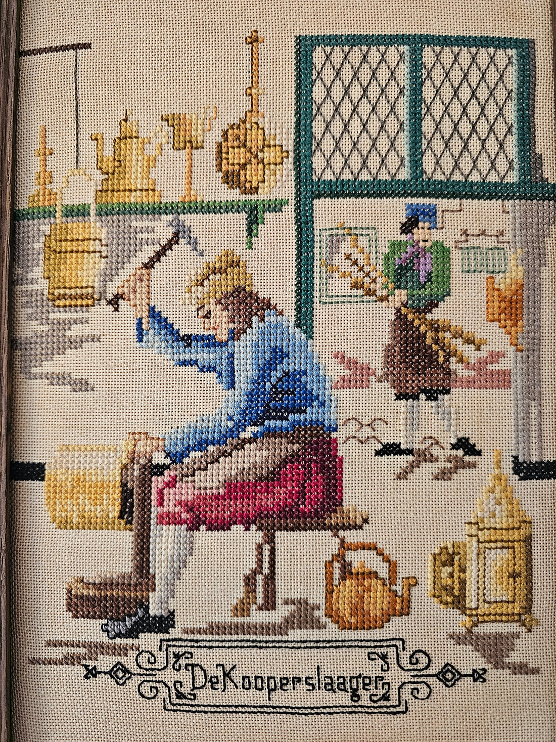 Geborduurd schilderij "de koperslaager"