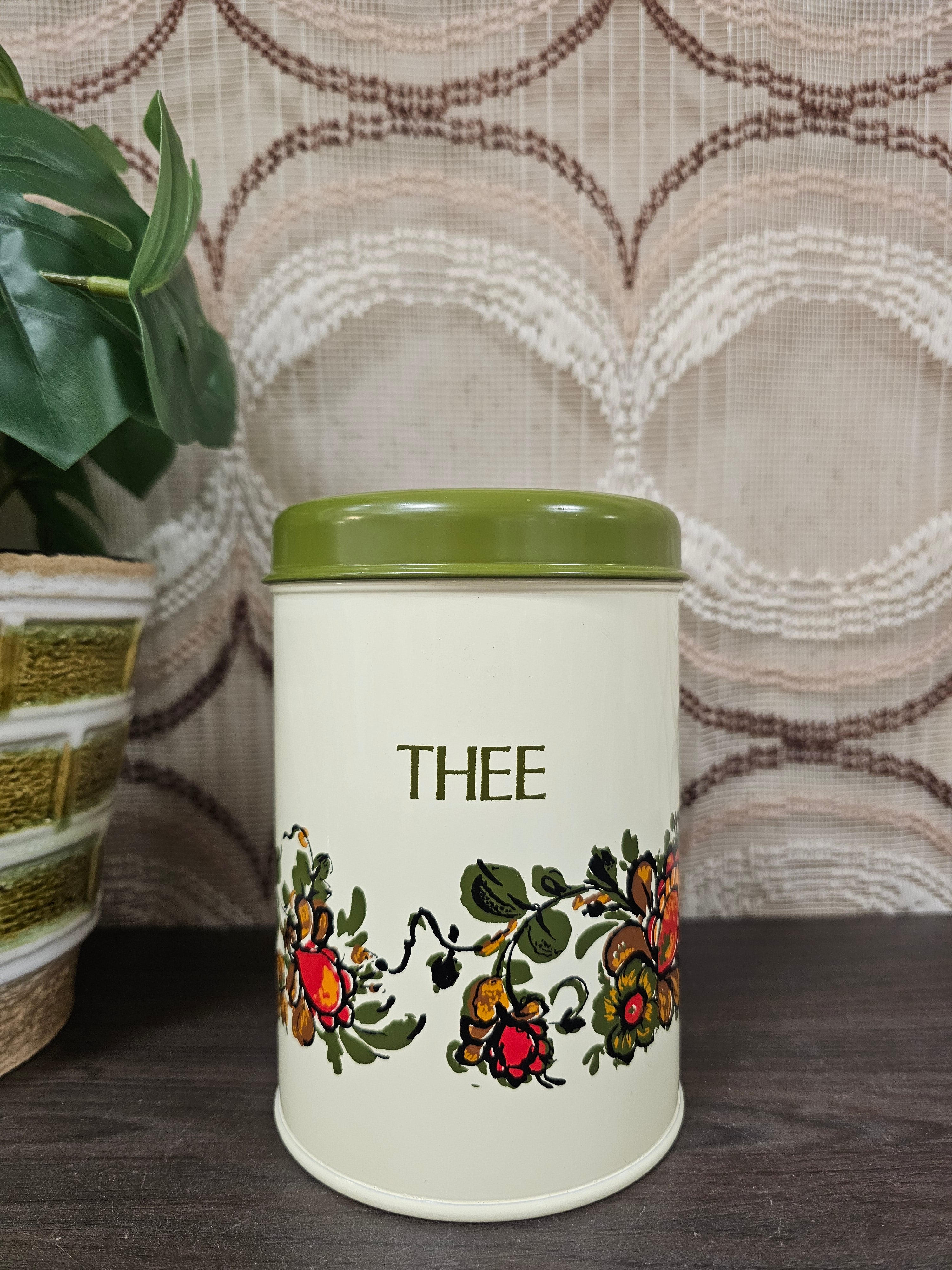 Vintage metalen thee blik met bloemen en groene deksel