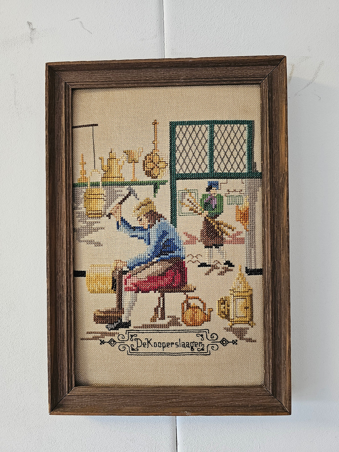 Geborduurd schilderij "de koperslaager"