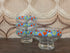 vintage glazen dessertschaaltjes op voet met blauw, rood, groen en wit decor.