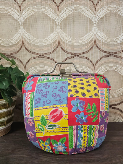 Vintage Douwe Egberts theebeurs met knip en kleurrijk bloemenpatroon