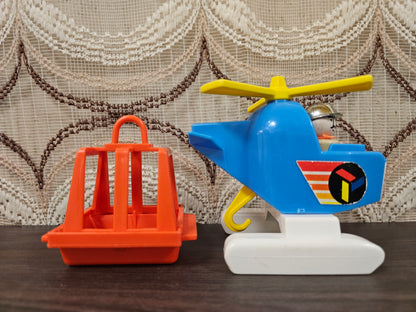 Fisher-Price helikopter blauw-wit met oranje reddingskooi – jaren 70 speelgoed
