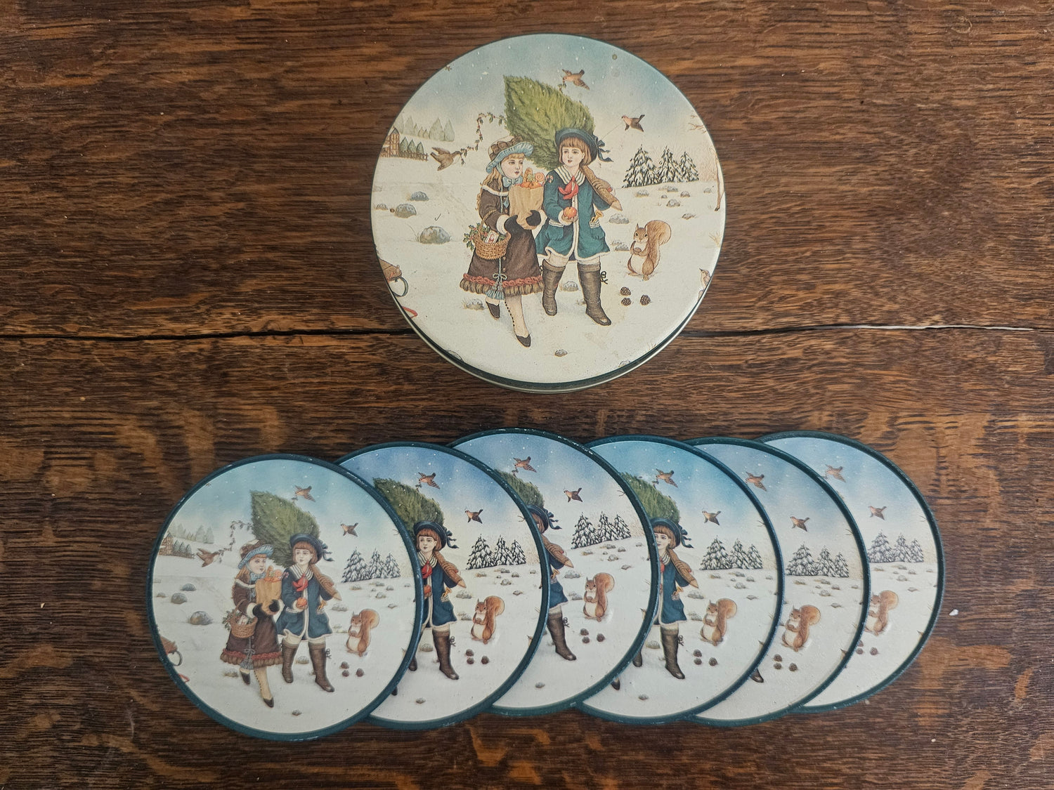Set van zes onderzetters met winterse illustratie in bijpassend blikje
