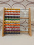 Vintage SIO houten telraam met gekleurde kralen in geel, oranje, rood, groen en blauw