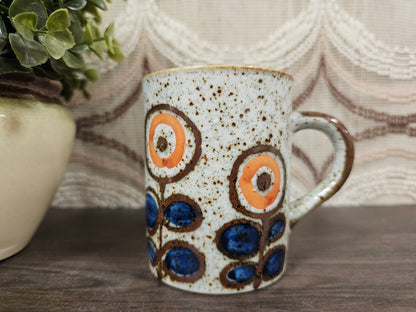 Vintage gespikkelde mok met blauw-oranje bloemenmotief, 9,5 cm hoog