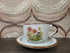 Vintage Wildflower kop en schotel van lichtgekleurd keramiek met subtiele spikkels, bruine rand en een decor van roze bloemen met kleine veldbloeme
