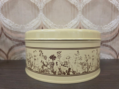Vintage Brabantia koektrommel van metaal met het bruine Flora-patroon.