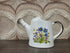 Wildflower keramieken gieter met blauwe en paarse bloemen, tuit links en handvat rechts